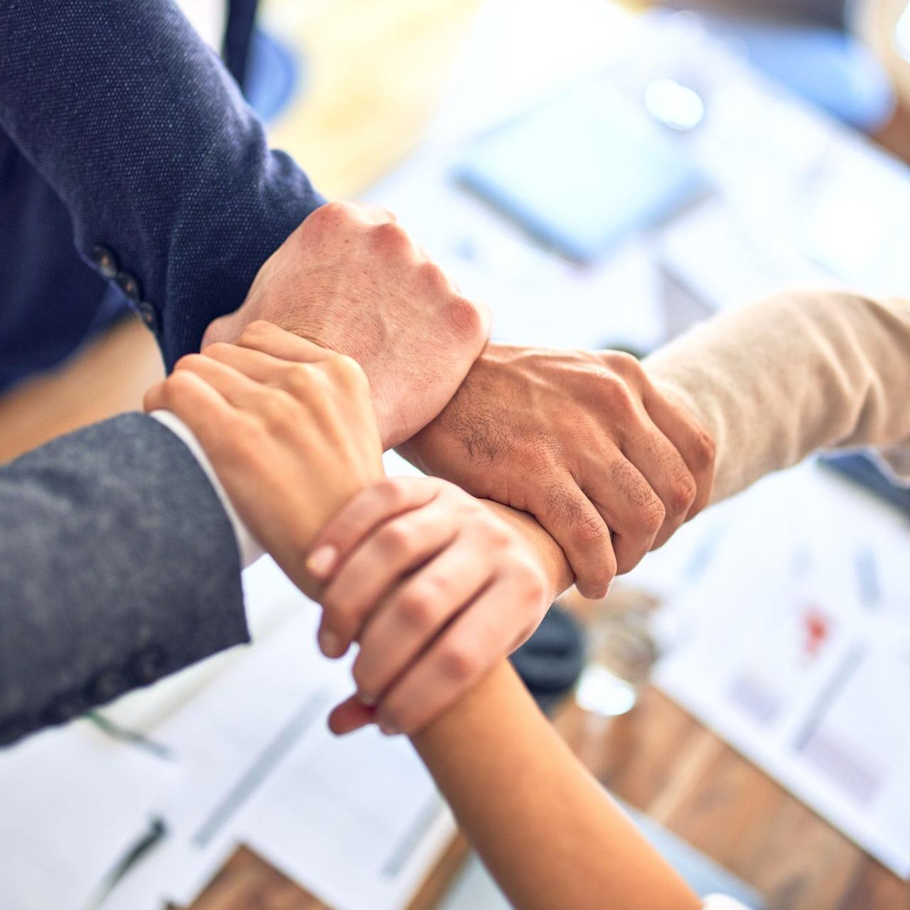 person in black long sleeve shirt holding persons hand